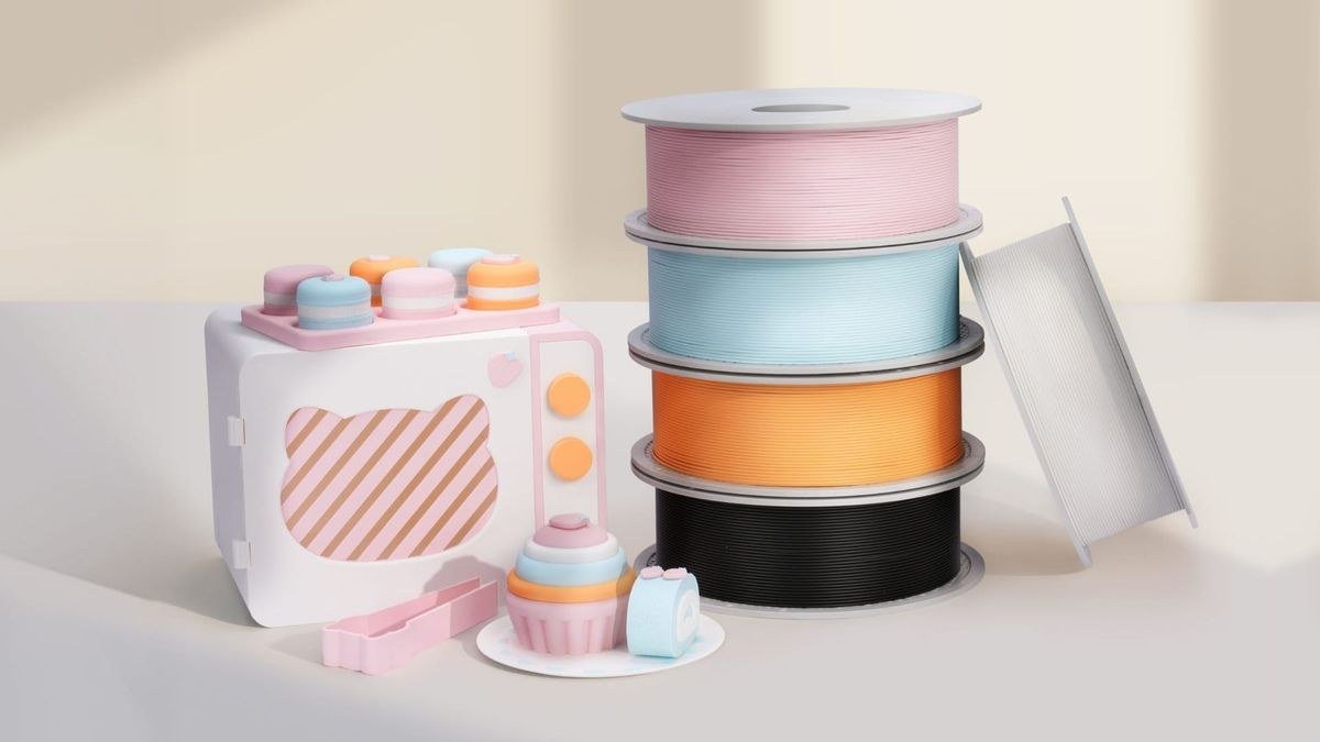 Bambu Lab PLA Pure filament spools in pink blue orange and black with 3D printed objects