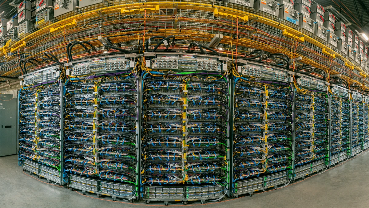 A Google Cloud TPU datacenter floor shows the compute that drives AI inference cost.