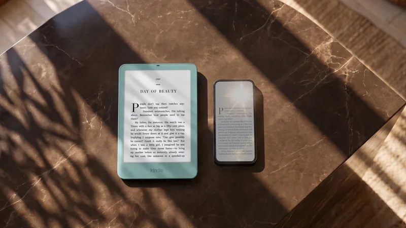 Amazon Kindle e-reader in teal beside a smartphone on a marble table, both showing a page of text