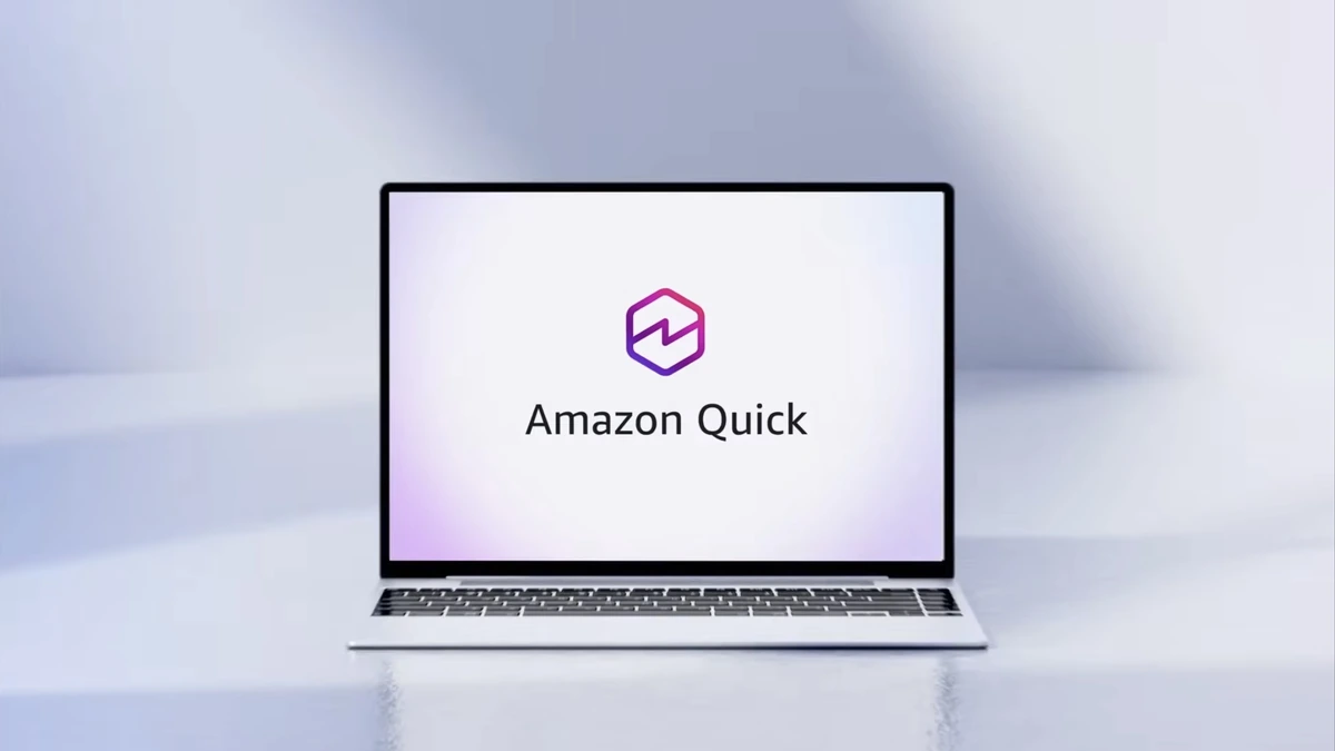 Amazon Quick logo and wordmark on a laptop screen against a pale gray backdrop
