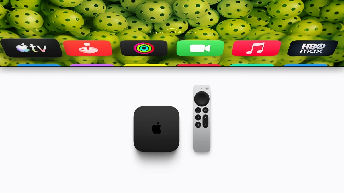 Apple TV 4K box beside its gray Siri Remote under a TV screen strip showing streaming app icons