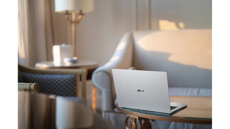 ASUS ExpertBook A7 silver laptop open on a side table beside a sofa