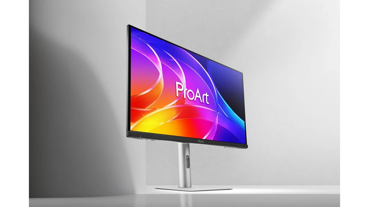 ASUS ProArt Display OLED PA279CDV monitor on a silver stand showing a colorful abstract wallpaper in a gray studio