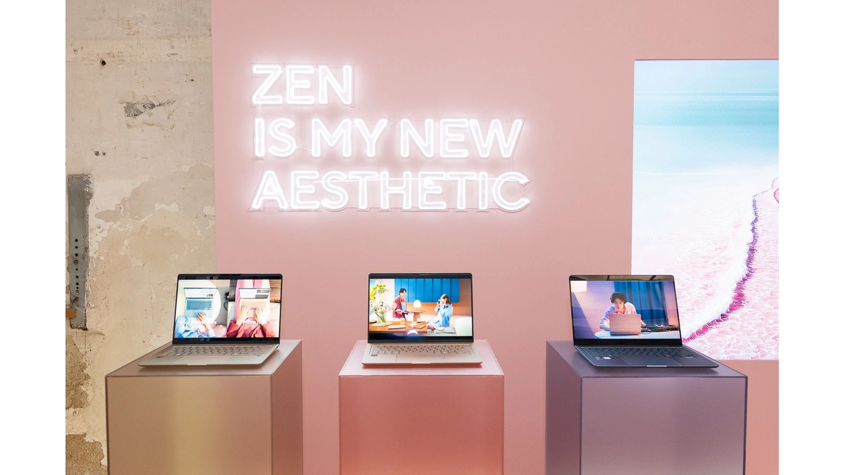 ASUS Zenbook 14 laptops on pedestals in a pink room with a neon sign reading Zen is my new aesthetic