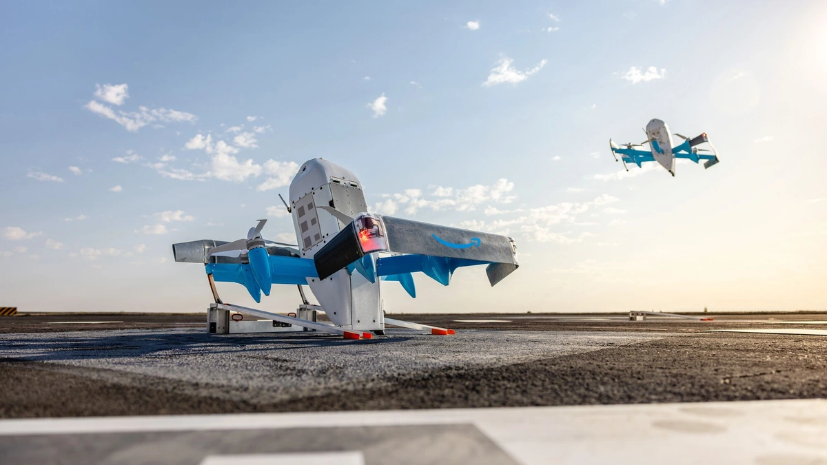Amazon MK30 delivery drone parked on a launch pad while a second drone flies nearby