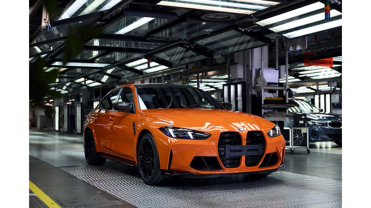 Orange BMW M3 from BMW Group parked in a factory assembly hall
