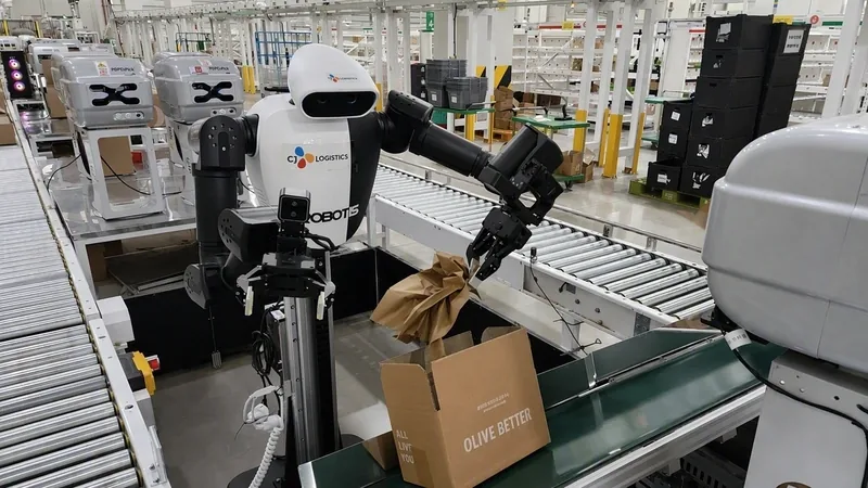 A CJ Logistics humanoid robot with a robotic arm packing a cushioning wrap into an Olive Better box on a warehouse conveyor