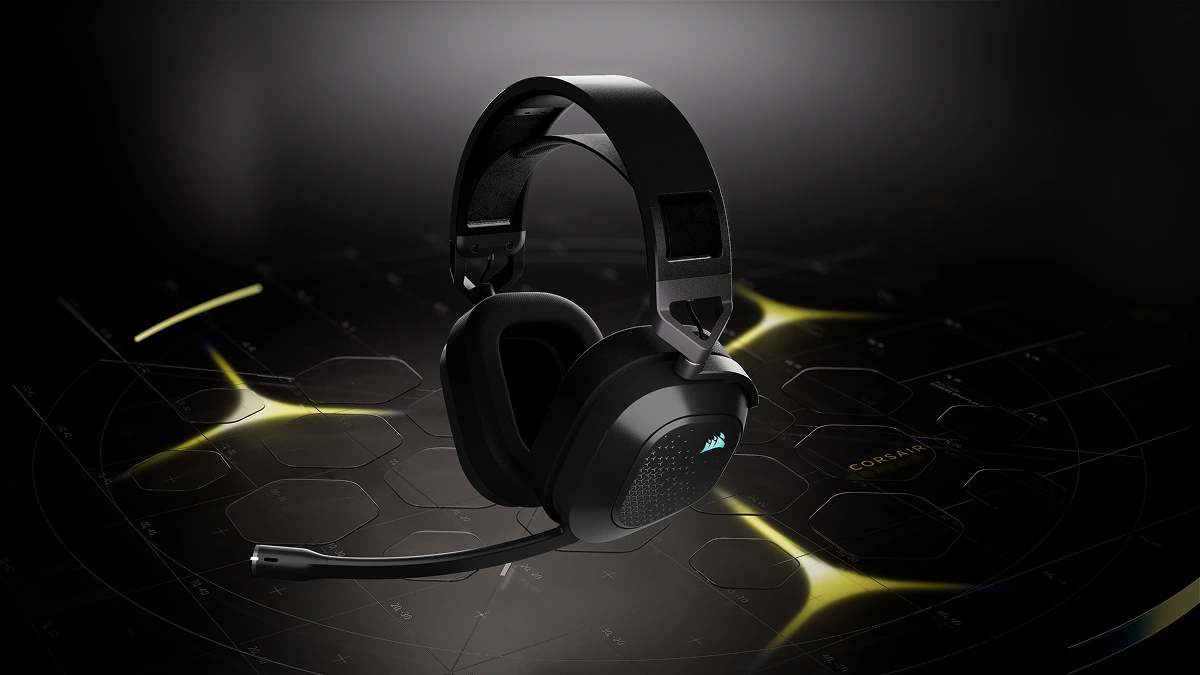 Black Corsair HS80 v2 MAX wireless headset with its boom mic, on a dark stage with yellow light accents