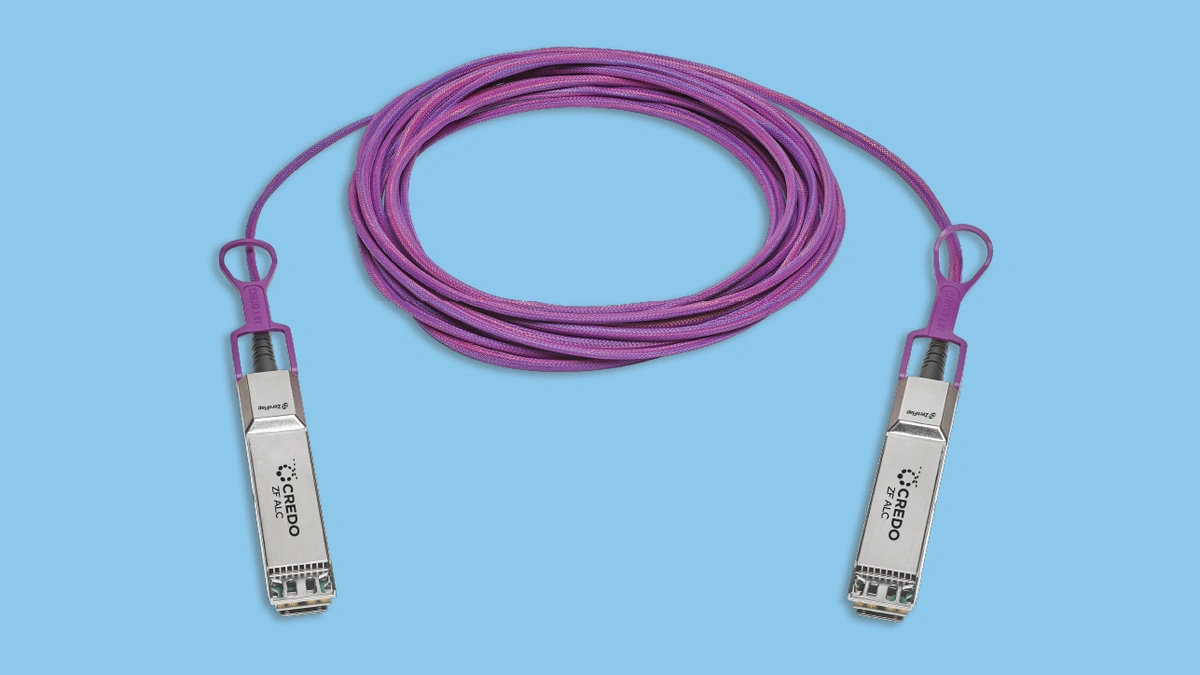 ZeroFlap ALC active light cable coiled in magenta with two silver connectors on a light blue background