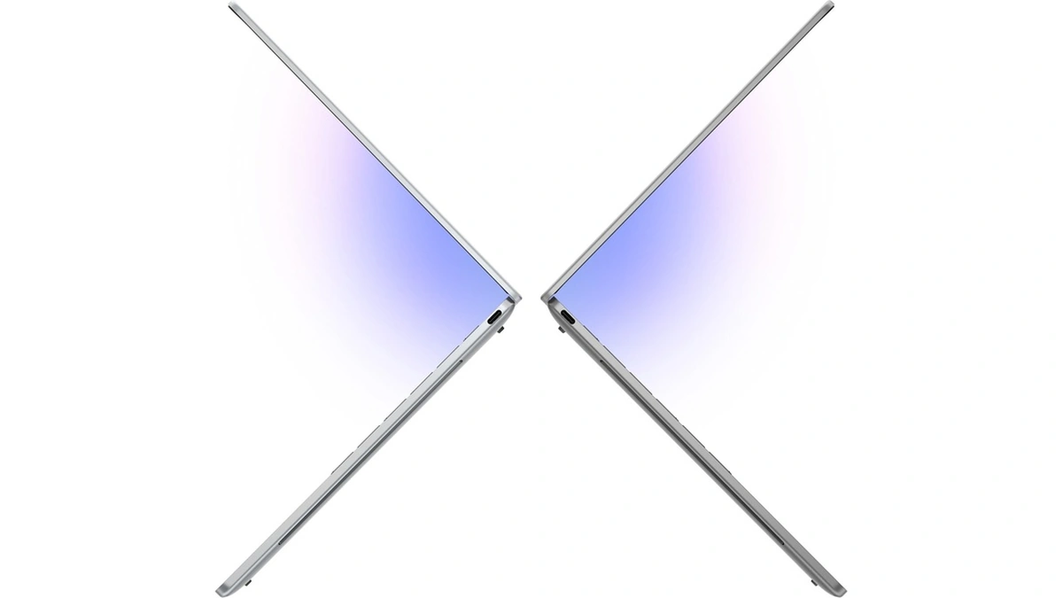 Dell XPS 13 laptop side profile in two mirrored views with a soft pink screen glow