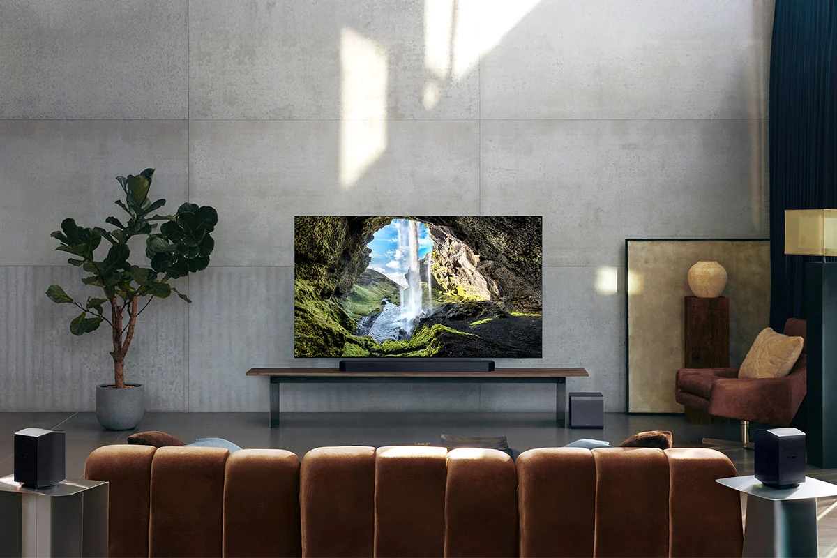 Living room shows a home theater audio setup: a soundbar below a TV facing a brown sofa
