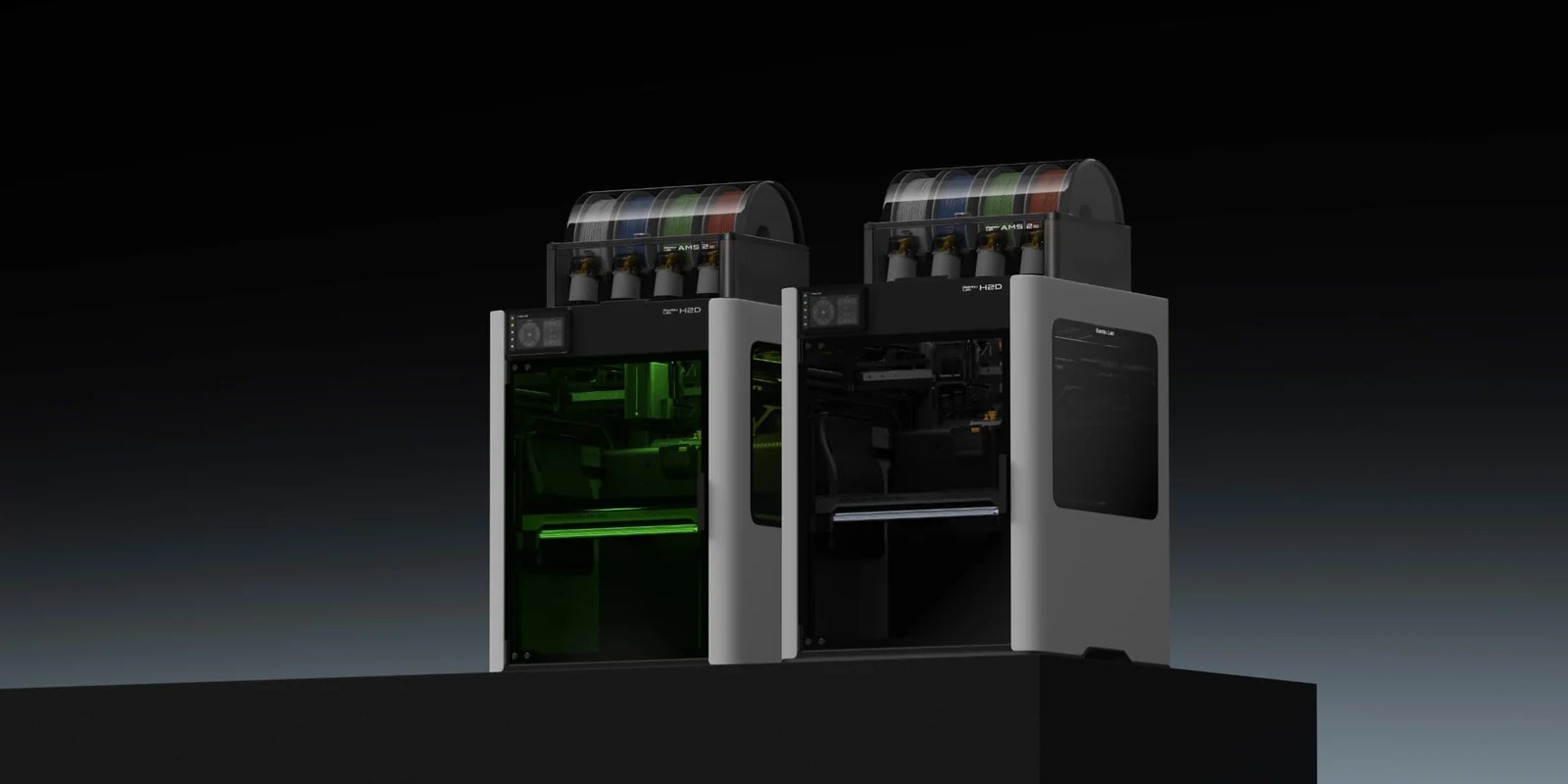 Two Bambu Lab H2D 3D printers show filament spools on top against a dark background