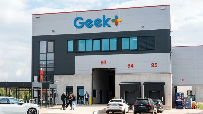 Geekplus facility in Düsseldorf with its logo above the loading bays and parked cars out front