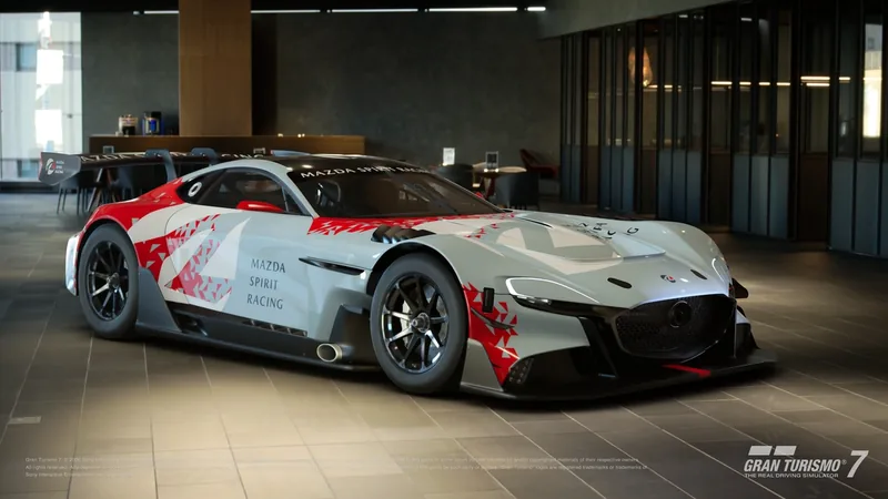 Gran Turismo 7 race car in white and red Mazda Spirit Racing livery parked indoors on a tiled floor