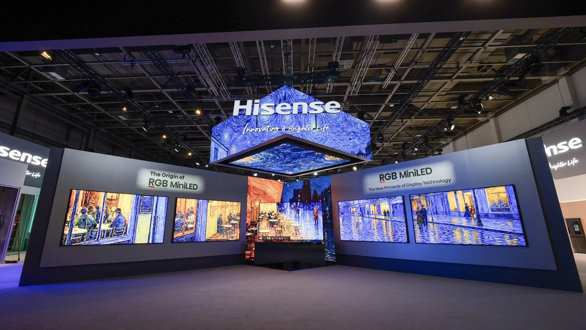 Hisense RGB MiniLED booth with wall-sized TVs displaying colorful paintings under hanging logo