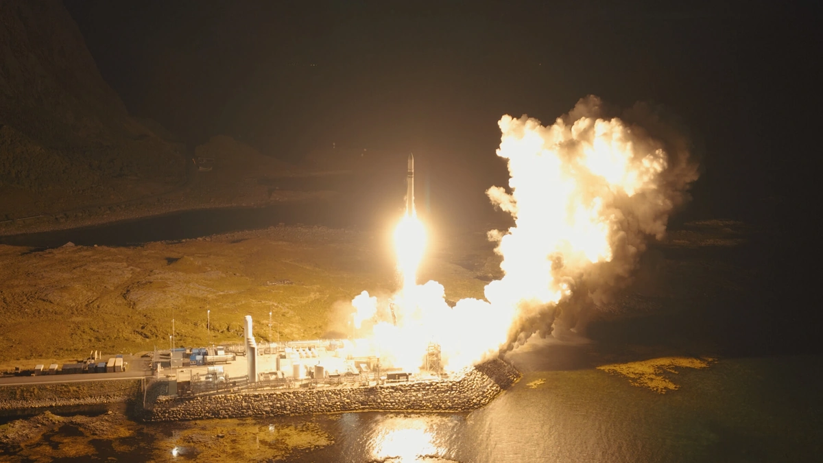 Isar Aerospace's Spectrum rocket lifting off at night from the coastal launch pad at Andøya Spaceport, Norway