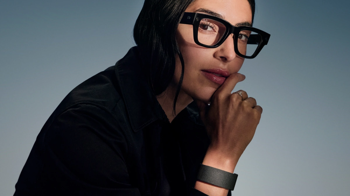 Meta Ray-Ban Display glasses worn by a woman with a black wristband, resting her chin on her hand