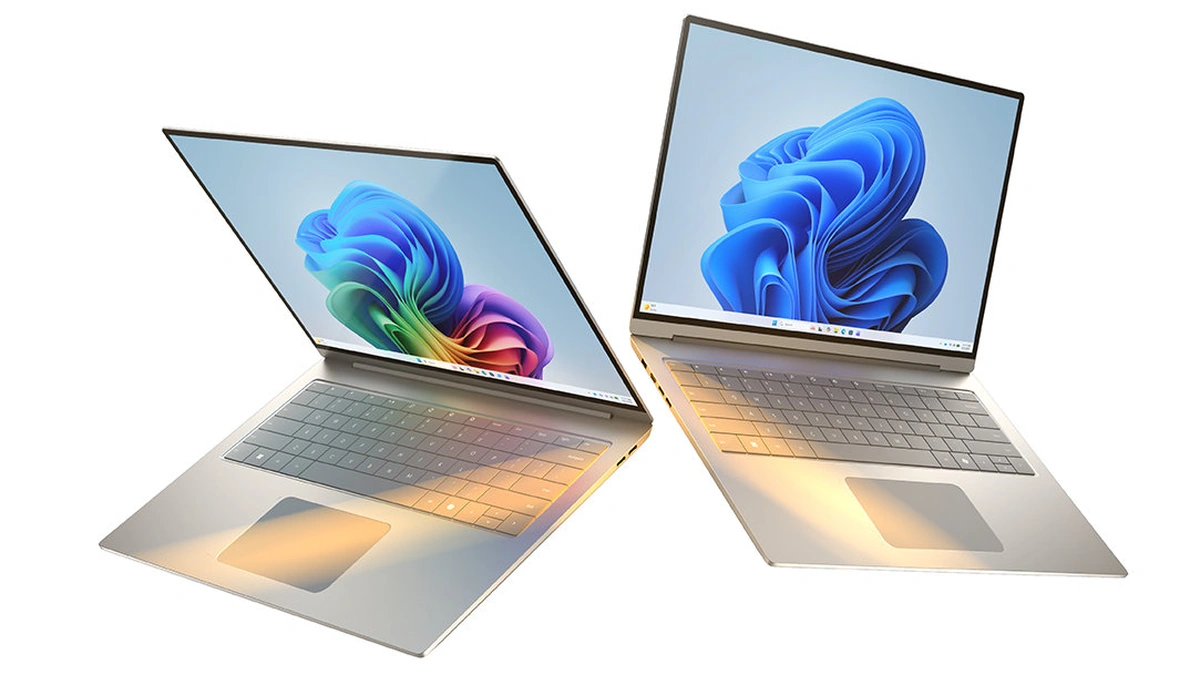 Two Copilot+ PC laptops open with colorful Windows wallpaper on their screens on a white background