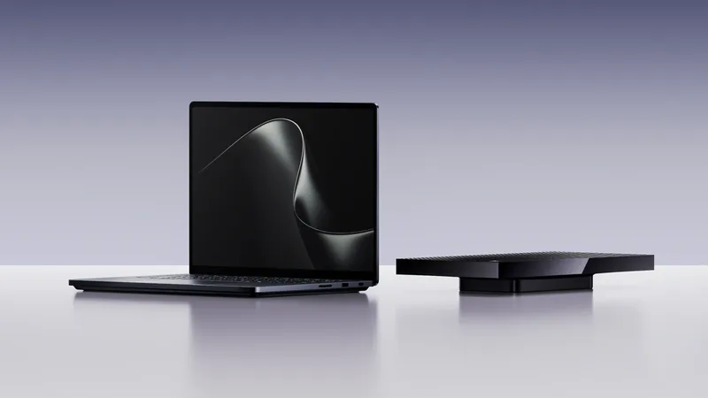 Microsoft Surface Laptop Ultra open on a white surface beside a black Surface RTX Spark Dev Box