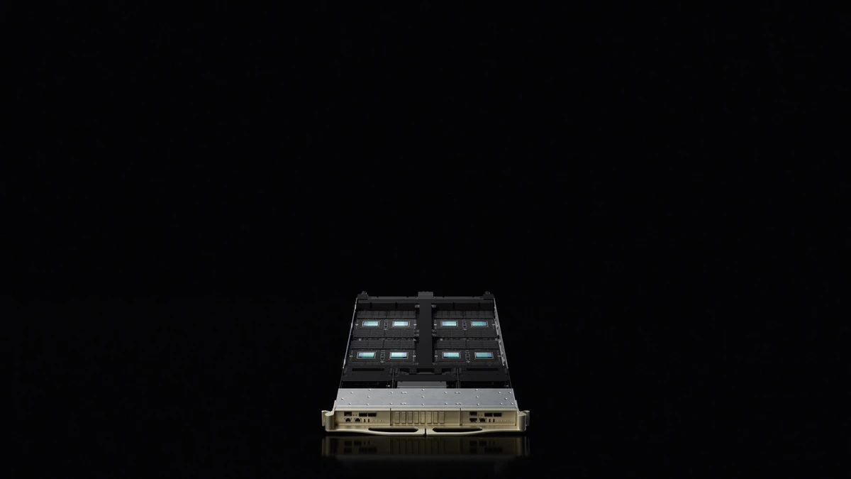 Open NVIDIA server tray with four teal processor modules in a 2x2 grid against a black studio field