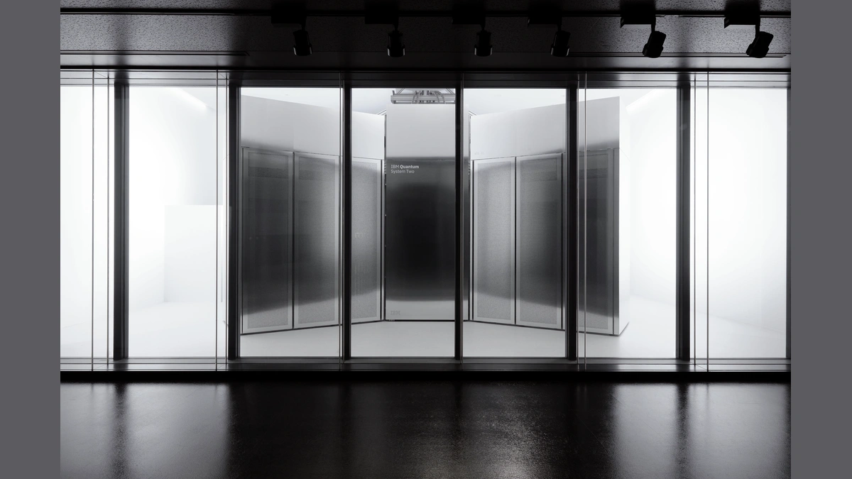 A large glass enclosure with the text "IBM Quantum System Two" visible on a central panel.