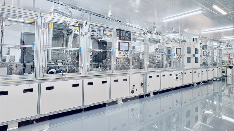 Battery research equipment lining a white cleanroom aisle at Energy Innovation Square