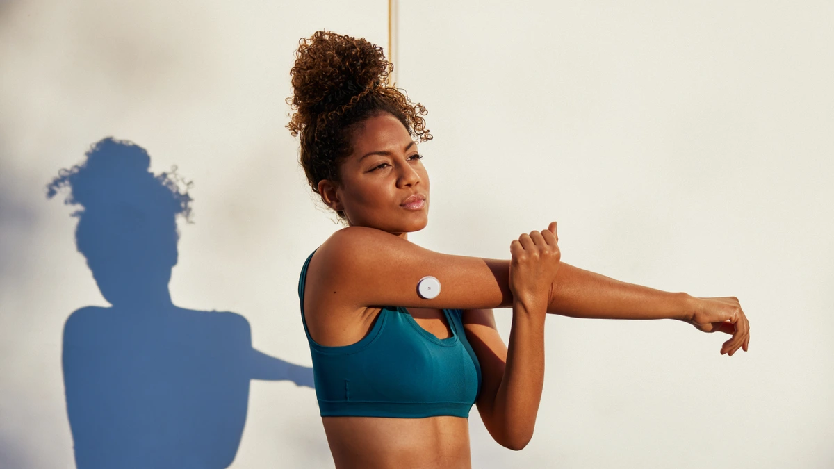Person wearing the Ultrahuman M2 Live sensor on the arm outdoors