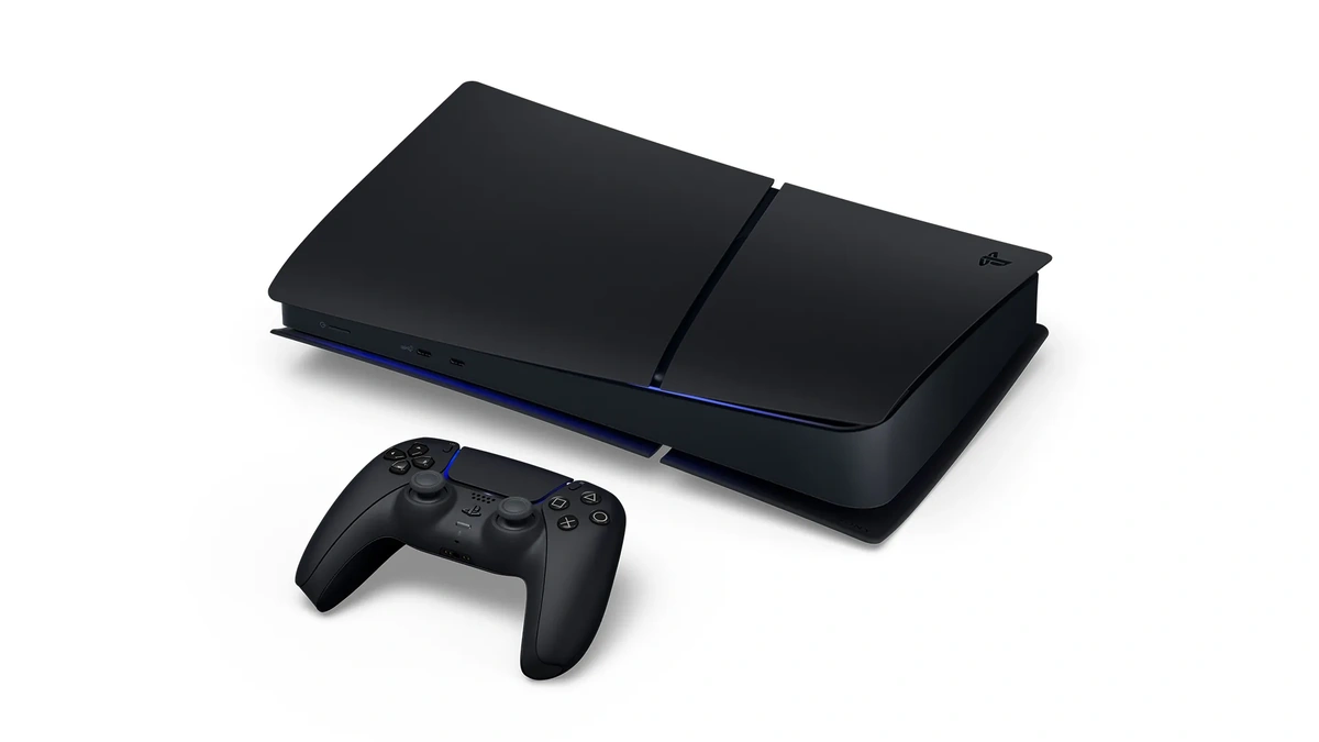 PlayStation 5 Digital Edition Midnight Black console lying flat beside a black DualSense controller on white