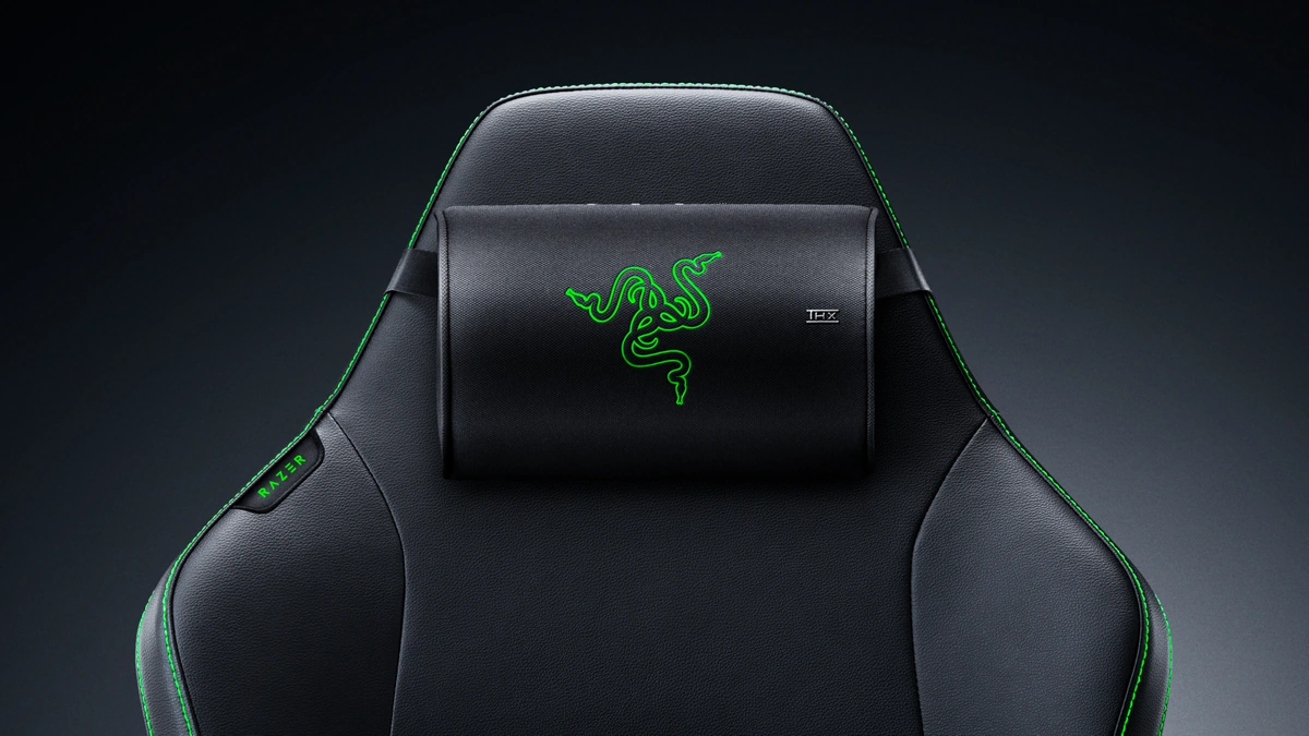 Razer Clio X wireless speaker head cushion mounted on a gaming chair headrest with green logo and THX badge