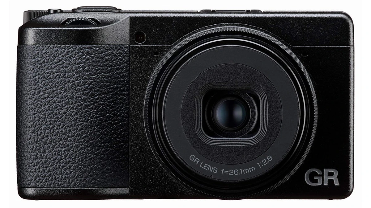 Front of a black Ricoh GR compact with GR LENS f=26.1mm 1:2.8 on the ring and a textured grip