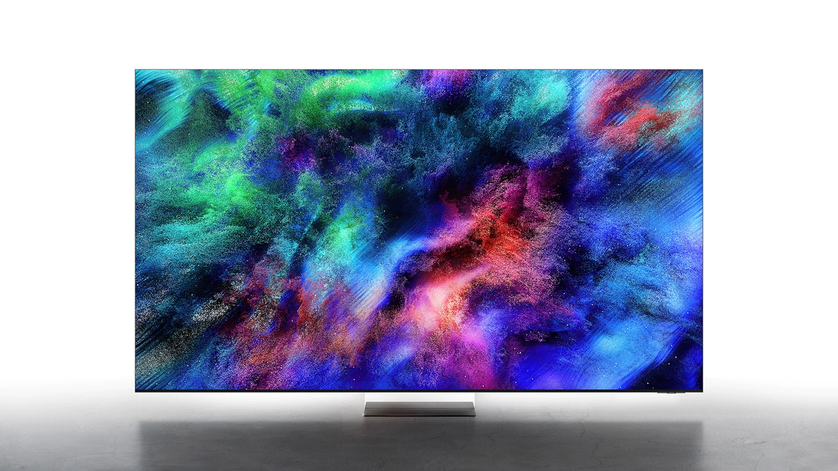 Samsung Micro RGB TV on a slim stand showing a colorful abstract image in a bright gray room