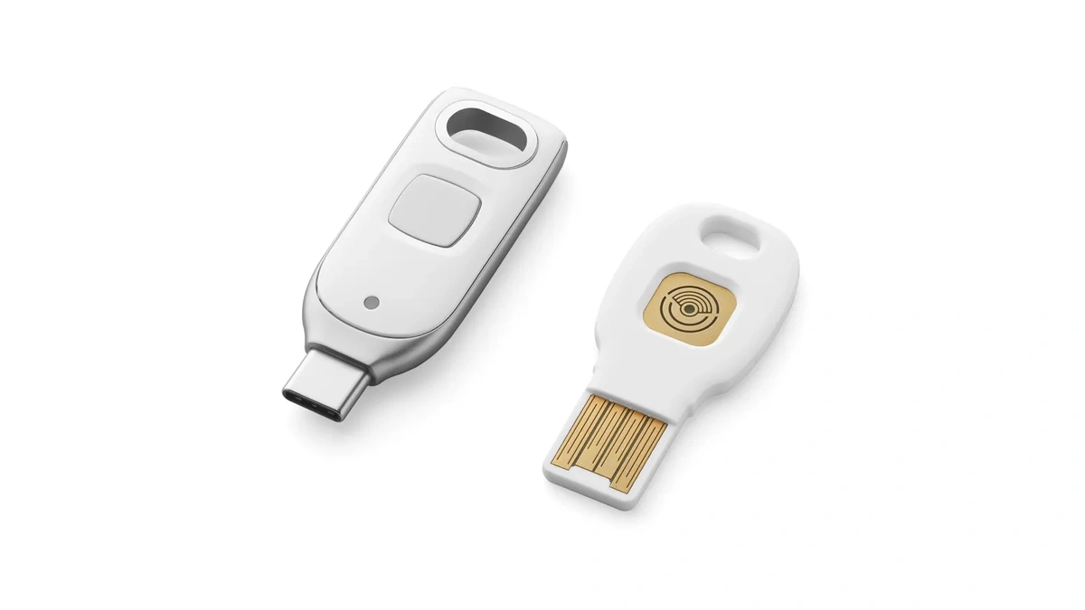 Google Titan Security Key in USB-C and USB-A versions, two white keys, the USB-A one with a gold touch pad