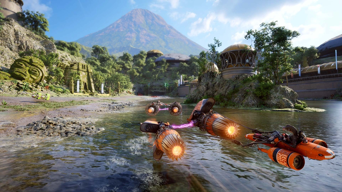 Podracers racing along a river beneath a volcano in Star Wars: Galactic Racer