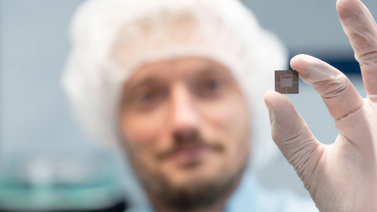 TRUMPF employee holding a microchip with an integrated laser-formed cooling structure