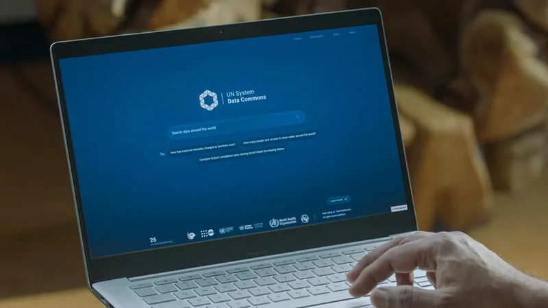 UN System Data Commons search page open on a laptop screen as a hand rests on the keyboard