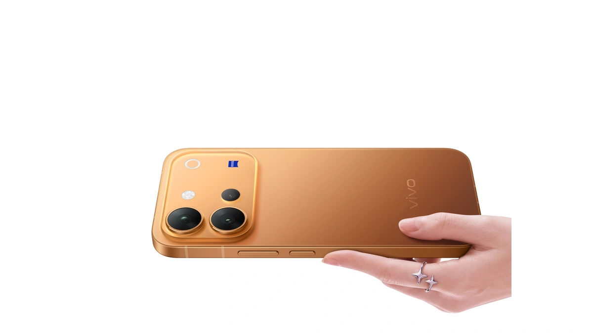 vivo V80 in orange held in a hand, rear camera module facing out