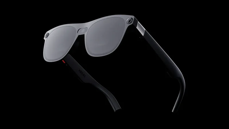 Xreal Aura glasses in black on a dark background